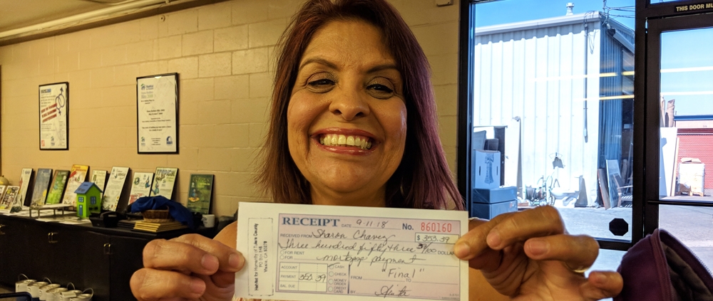 Sharon Chavez with last mortgage payment for Habitat
