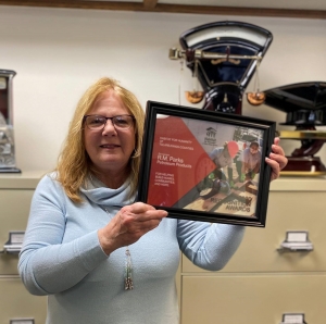 Jeanette Constantino from R.M. Parks holding award