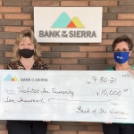Habitat staff and Bank of The Sierra staff holding check for $10,000